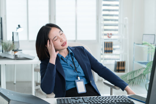 Young Businesswoman Working at Office Desk While Managing Documents and Mobile Communication.