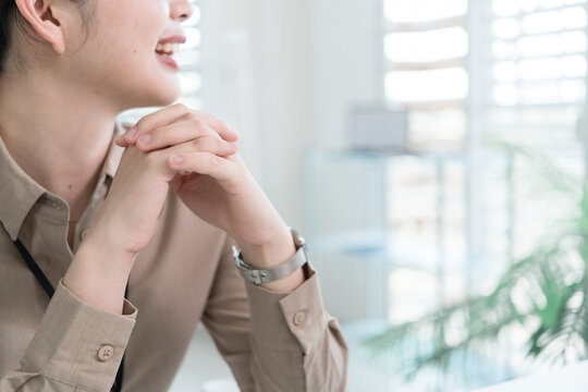 Young Businesswoman Working at Office Desk While Managing Documents and Mobile Communication.