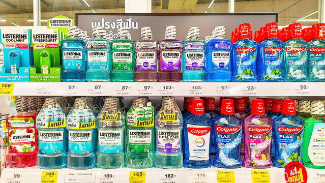 A well-stocked aisle in a retail store showcases a variety of Listerine, Colgate mouthwash bottles, arranged neatly on shelves, highlighting oral hygiene products. Thailand, August 7, 2026
