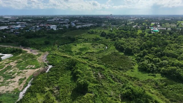 Circular lagoon and grass field surrounded on top view. Hiding unseen landscape in Thailand.