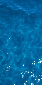 Deep blue ocean water with gentle ripples, reflecting sunlight,  calm,  deep