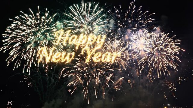 Happy New Year Glowing Lettering Over Stunning Fireworks Explosion Displaying in the Dark Night Sky