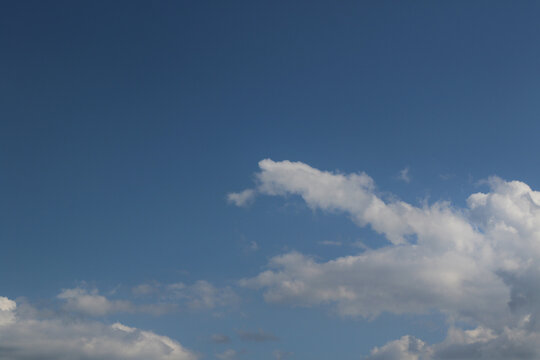 blue sky with white cumulus clouds and copy space