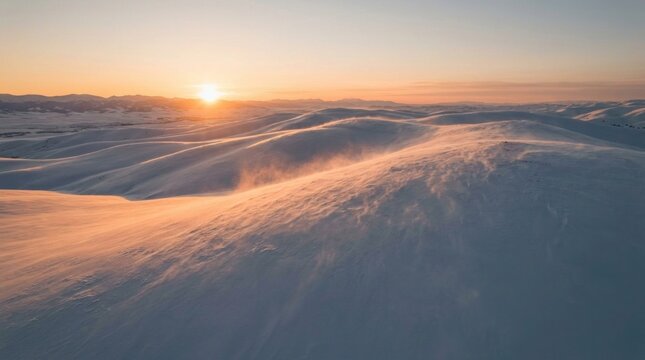 Sunset over snow covered mountain range