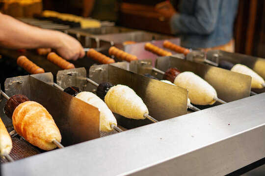 Trdelnik or trdlo is traditional Czech sweet. Woman hand keep trdlo in Prague street. Street food.