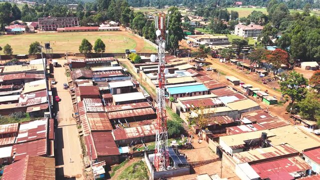Communication mask, telecommunication Aerial wide shot of showing modern skyline of Rural kenya settlement with old architectures in background and poor ghetto suburb district of Kibera.