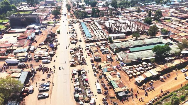 Aerial wide shot of showing modern skyline of Rural kenya settlement with old architectures in background and poor ghetto suburb district of Kibera in foreground.