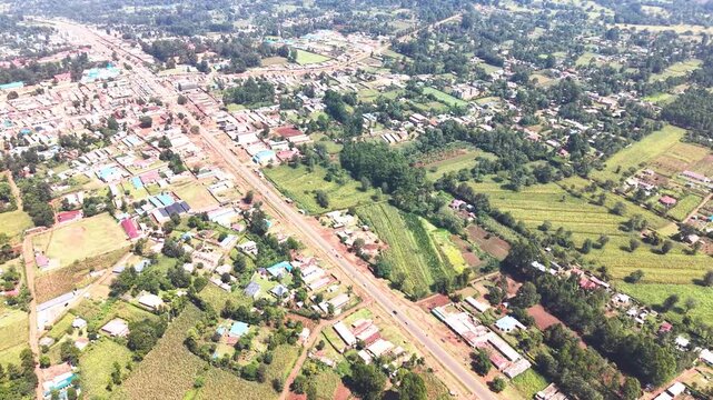 Aerial wide shot of showing modern skyline of Rural kenya settlement with old architectures in background and poor ghetto suburb district of Kibera in foreground.