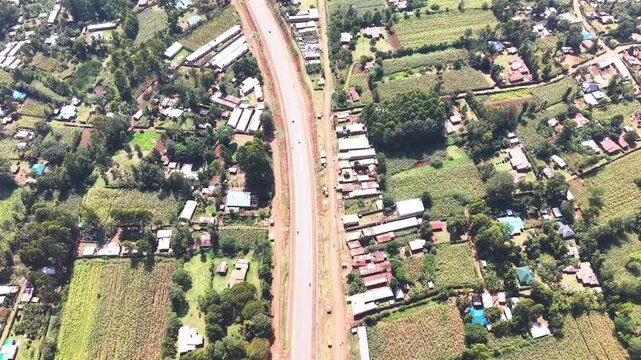 Aerial wide shot of showing modern skyline of Rural kenya settlement with old architectures in background and poor ghetto suburb district of Kibera in foreground.