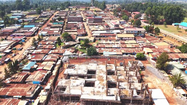Aerial wide shot of showing modern skyline of Rural kenya settlement with old architectures in background and poor ghetto suburb district of Kibera in foreground.