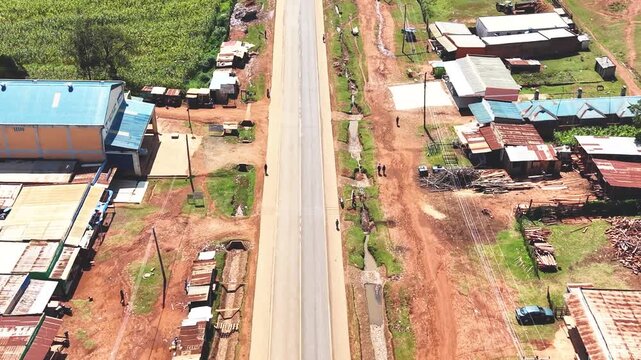 Aerial wide shot of showing modern skyline of Rural kenya settlement with old architectures in background and poor ghetto suburb district of Kibera in foreground.