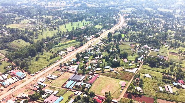 Aerial wide shot of showing modern skyline of Rural kenya settlement with old architectures in background and poor ghetto suburb district of Kibera in foreground.