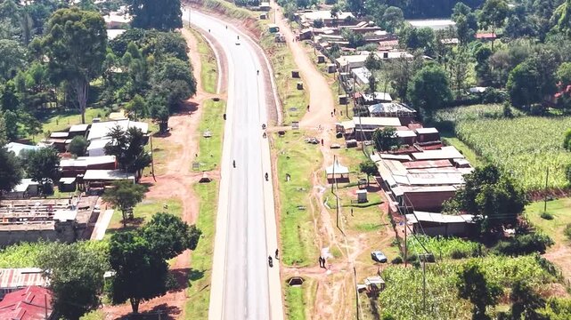 Aerial wide shot of showing modern skyline of Rural kenya settlement with old architectures in background and poor ghetto suburb district of Kibera in foreground.