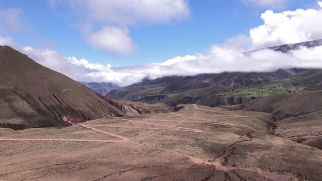4K drone aerial view of the winding mountain road to Iruya, Jujuy, Argentina. Scenic zigzag route crossing the Andes with dramatic landscapes and remote valleys.