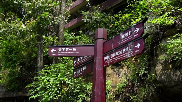 Wooden signpost with directions in chinese at Yuanjiajie, Zhangjiajie National Forest Park, Hunan