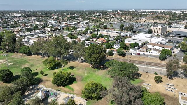 Aerial drone footage of a Metro A Line train traveling along the rail tracks near Veterans Park in Long Beach, California, heading toward the Interstate 405 and Interstate 710 freeway interchange.