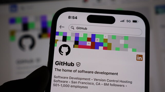 GitHub profile page on smartphone with pixelated banner and software development industry information.