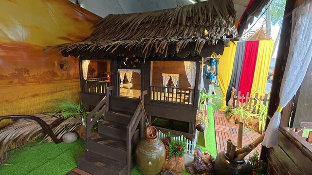 A detailed miniature replica shows a traditional Negeri Sembilan Malay house. It is displayed publicly to educate newer generations about Malaysian architectural heritage.