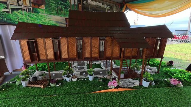 A detailed miniature replica shows a traditional Negeri Sembilan Malay house. It is displayed publicly to educate newer generations about Malaysian architectural heritage.