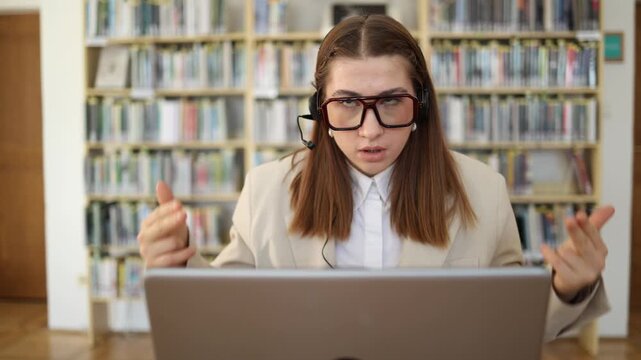 Call center employee makes a finger gun gesture at her head after a difficult customer call humorously showing extreme frustration and emotional exhaustion at work