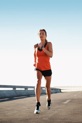 Obraz premium Fitness, woman and running exercise on bridge for workout challenge, athletic performance or health. Active, runner and sprint interval training on highway road for speed, stamina or pace improvement