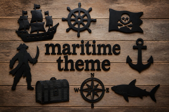 Various black maritime themed objects are arranged on a wooden surface.