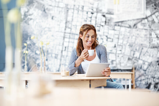 Coffee shop, laugh and woman on tablet for online article, social media and email in cafeteria. Happy, restaurant and person on digital tech for website, reading ebook and internet meme with drink