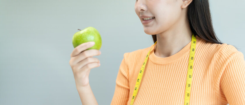 slim body asian women choose healthy foods, dieting female choose green apple for diet. Good healthy food. weight lose, balance, control, reduce fat, low calories, routines, exercise, body shape.