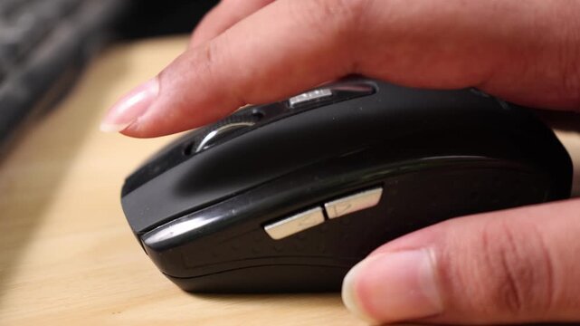Hand using a computer mouse while working