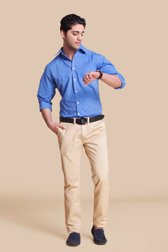 Portrait of young man looking at watch