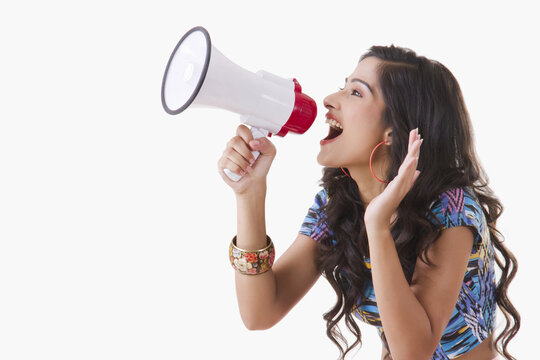 Young woman shouting through megaphone