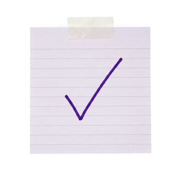 Square sticky paper note with a purple check mark drawn on it attached with adhesive tape