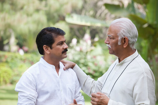 Father putting hand on sons shoulder