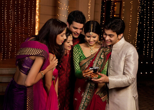 Friends looking at a picture on a camera