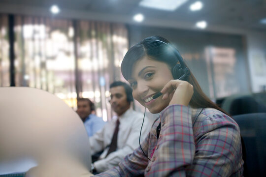 Portrait of female executive with headset