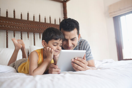 Father and son looking at a digital tablet