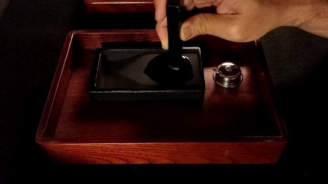 The traditional Far East Asian method of grinding ink sticks on a stone creates a moment of peace and relaxation before used it for writing or painting.