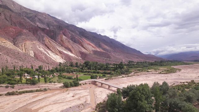 4K drone aerial view of Paleta del Pintor in Maimar&aacute;, Jujuy, Argentina. Iconic colorful mountain landscape in the Quebrada de Humahuaca, with vibrant geological layers shaped by erosion.
