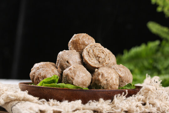 Handmade Teochew Beef Balls in Wooden Bowl - Traditional Chinese Soup Ingredient with Fresh Herbs