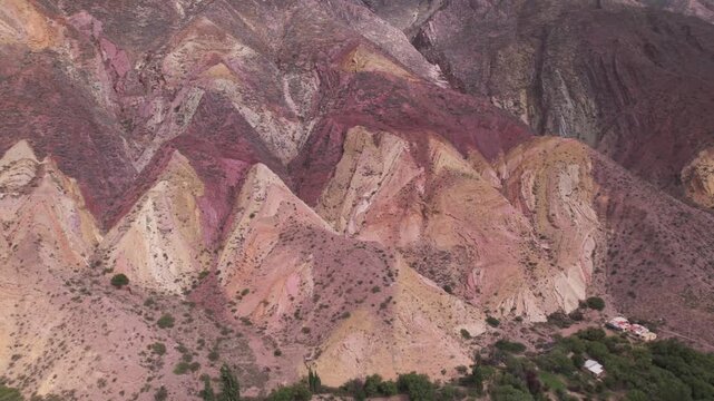 4K drone aerial view of Paleta del Pintor in Maimar&aacute;, Jujuy, Argentina. Iconic colorful mountain landscape in the Quebrada de Humahuaca, with vibrant geological layers shaped by erosion.
