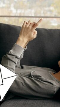 Man lying on a sofa and texting 4k