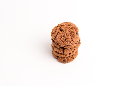 Tall neat stack of crunchy chocolate chip cookies isolated on a white background