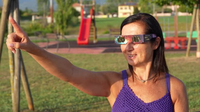 Woman witnessing solar eclipse using certified protective