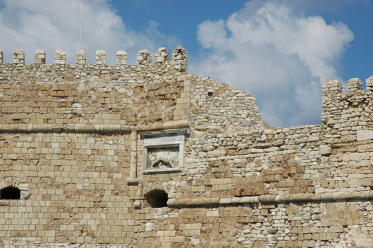 The carved marble relief of the Venetian Lion of Saint Mark is embedded in the stone battlements of Koules Fortress in Heraklion