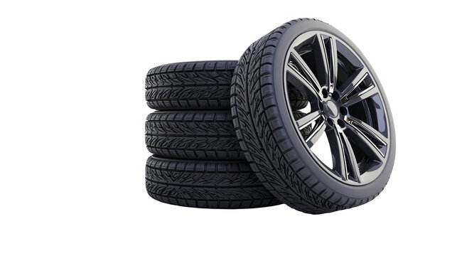 Stack of four car tires with one alloy wheel