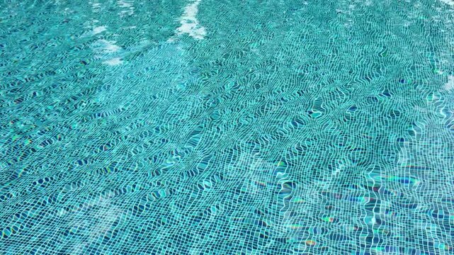 Swimming pool with blue crystal clear water surface and ripple wave background