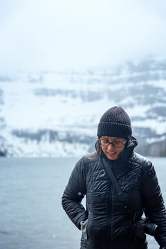 Woman enjoying snowing day at Cameron Lake in Waterton National Park