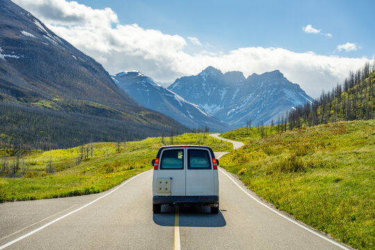 Camper van driving through Waterton Lakes National Park mountains