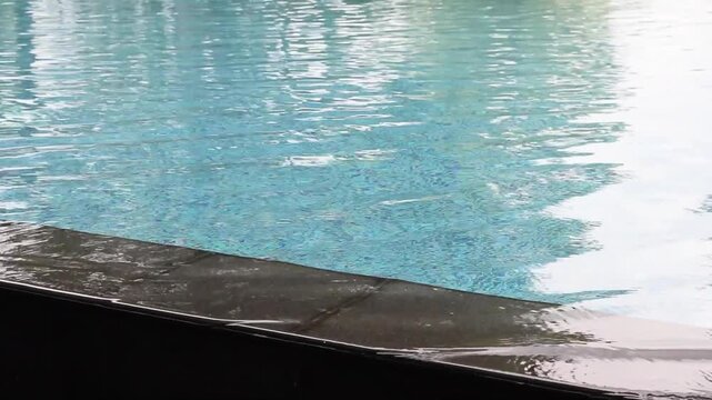 Empty stone edge of swimming pool with blurred background