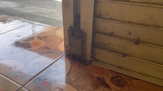 Close up of manual latch lock on a rolling door shutter